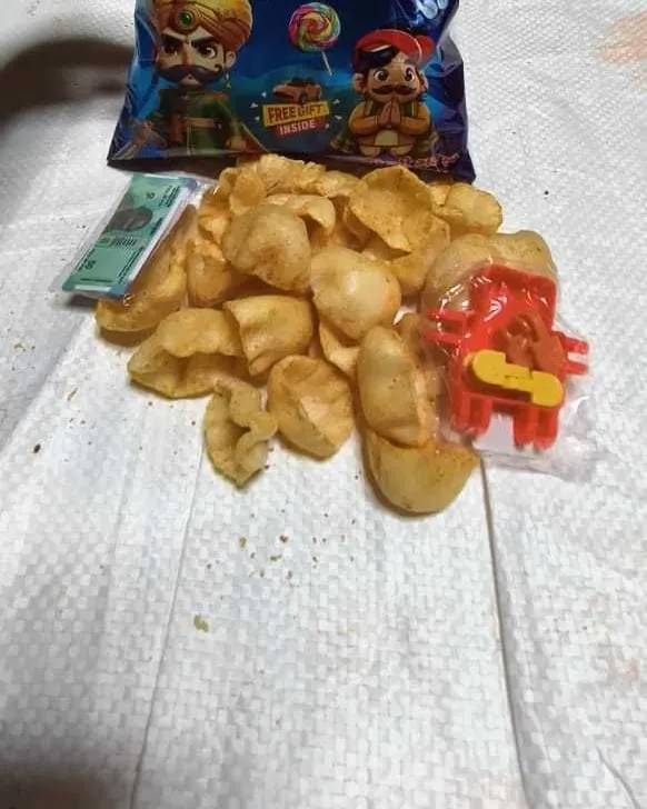 The Plastic toy + tattoo card that comes sealed inside a Raja Mantri pack, sitting among the snack